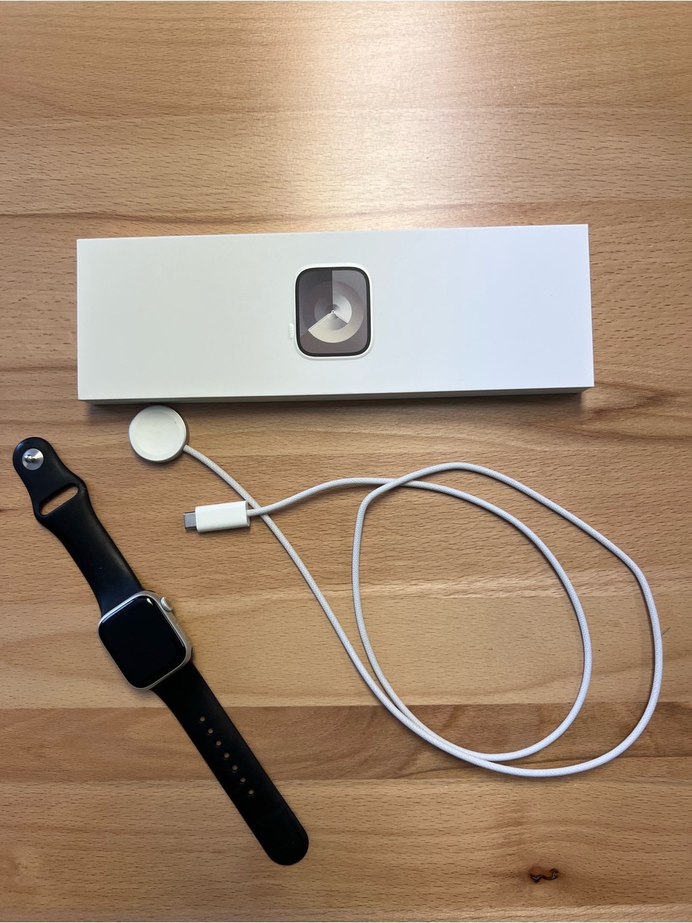 Apple Series 9Watch Silver Case with Black Sport Band and White Magnetic Charger